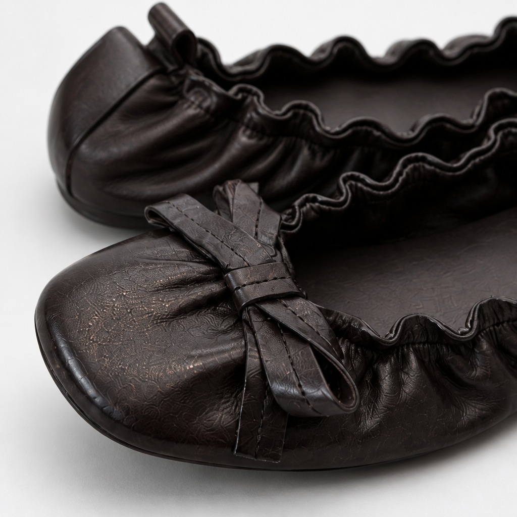 Toe and bow construction detail of black comfortable flat shoe