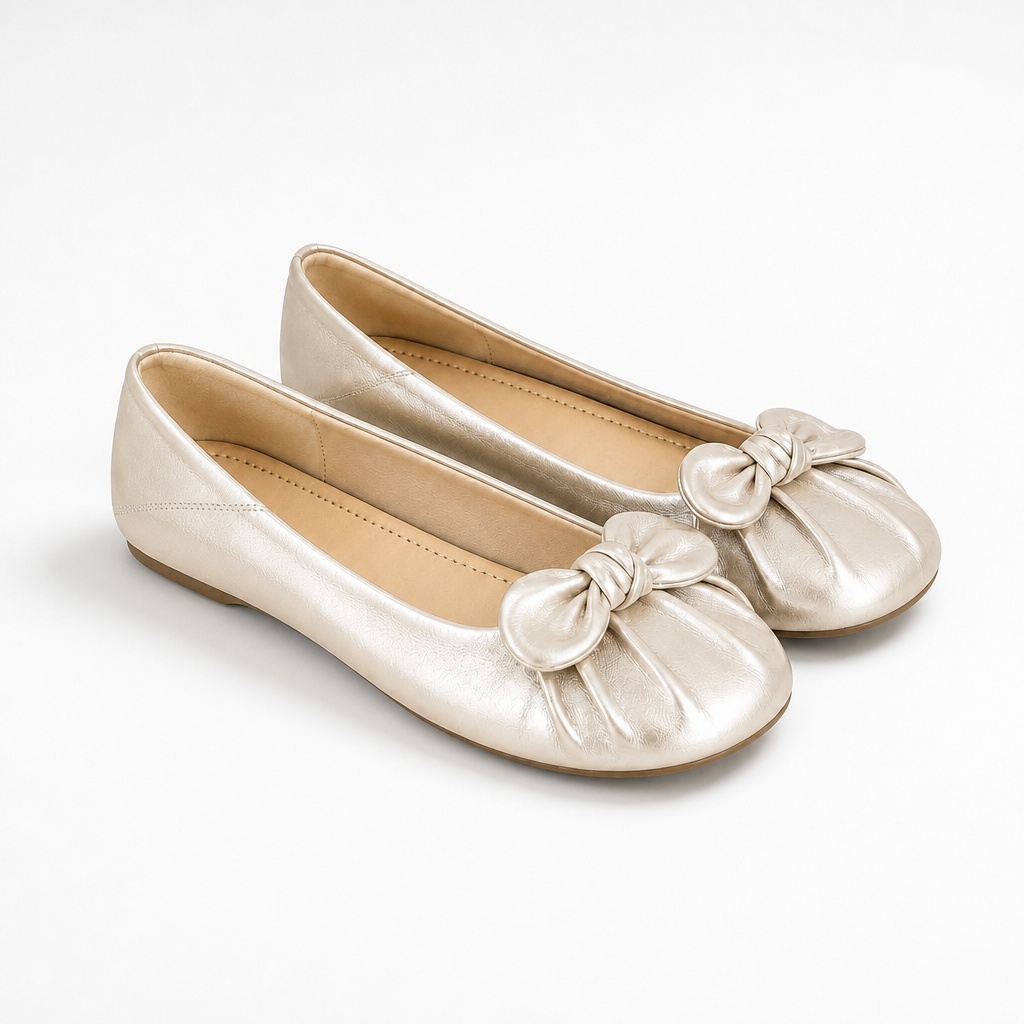 Pair of champagne gold flat shoes on a clean background