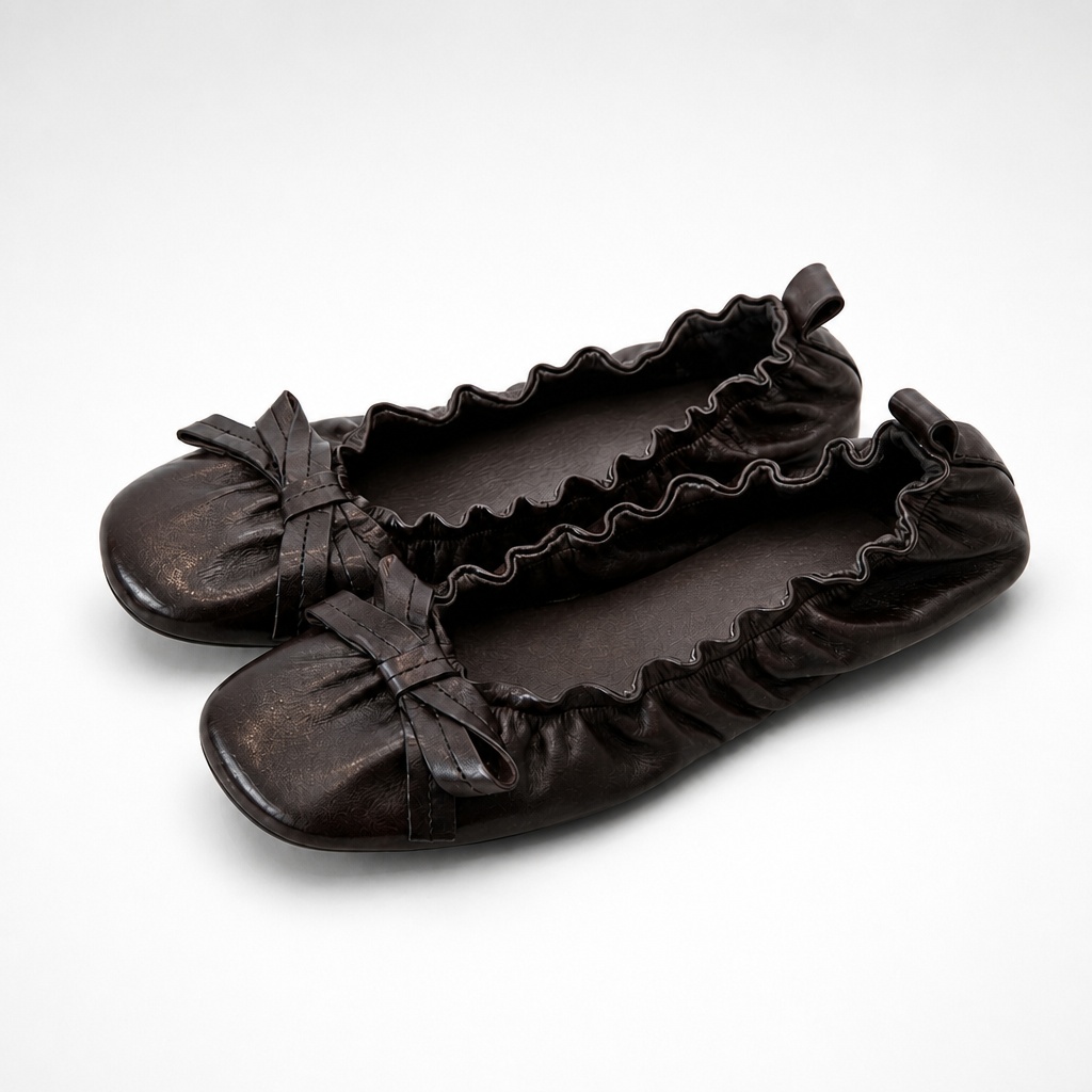 Pair of black flat heel shoes on white background